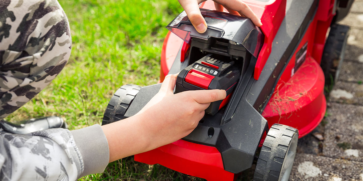 a cordless mower having its battery inserted