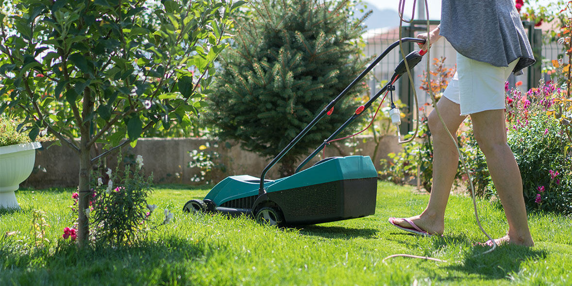 a corded mower being used on a lawn